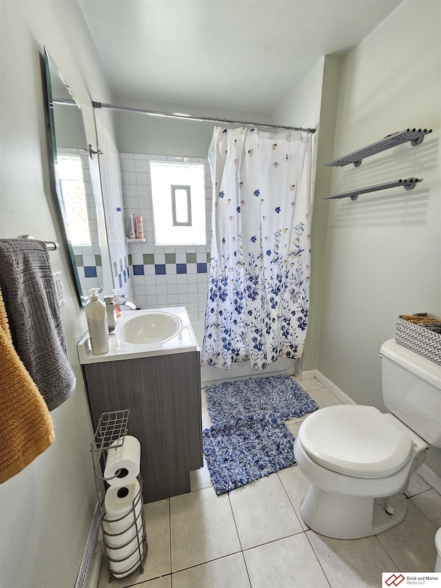 full bathroom featuring a shower with curtain, vanity, toilet, and tile patterned floors