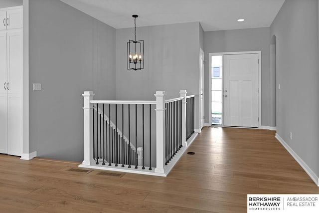 foyer featuring hardwood / wood-style floors and a chandelier