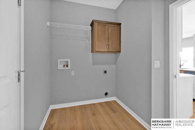 laundry room with light hardwood / wood-style flooring, electric dryer hookup, cabinets, and hookup for a washing machine