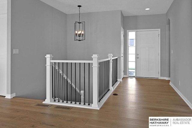 entryway with a chandelier and wood-type flooring