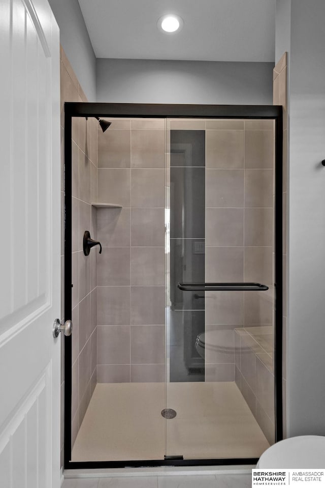 bathroom with walk in shower and toilet