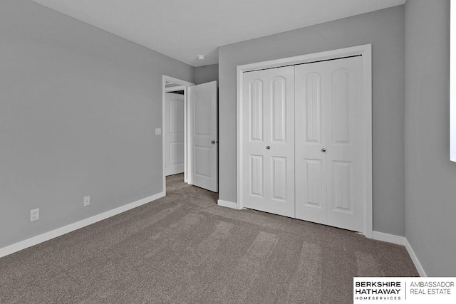 unfurnished bedroom with carpet flooring and a closet