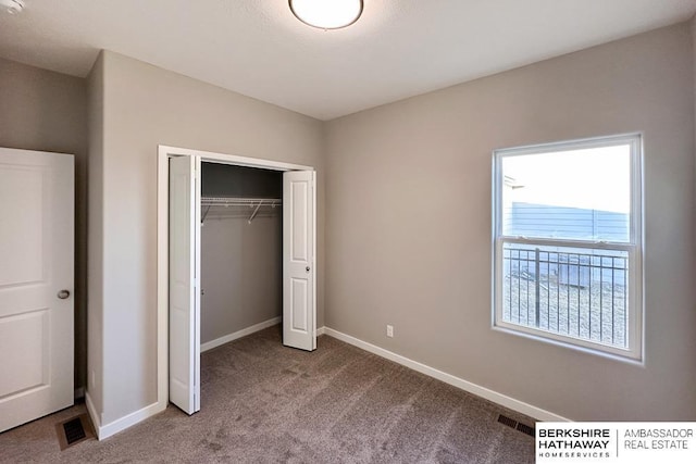 unfurnished bedroom with a closet and carpet