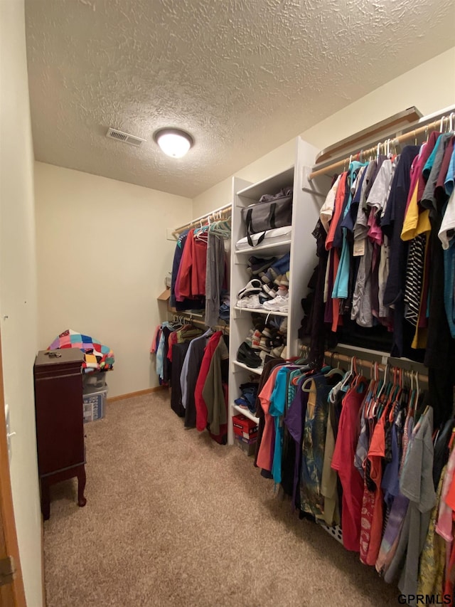 spacious closet with visible vents and carpet