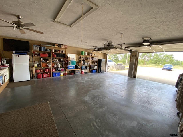 garage with a garage door opener and freestanding refrigerator