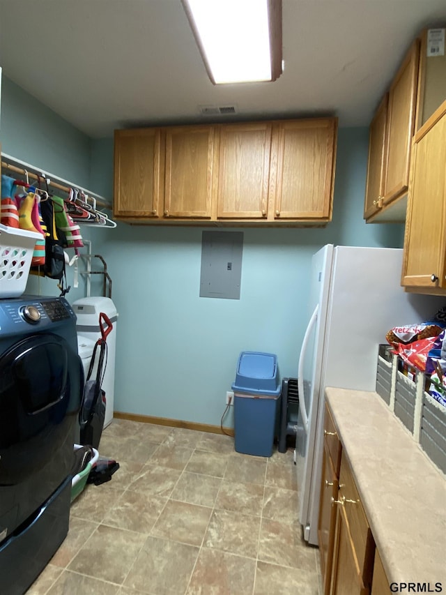 washroom with visible vents, baseboards, electric panel, cabinet space, and washer and clothes dryer