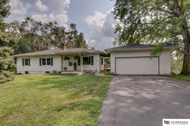 ranch-style home with a garage and a front lawn