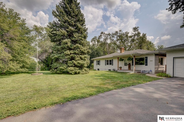 single story home featuring a garage and a front lawn