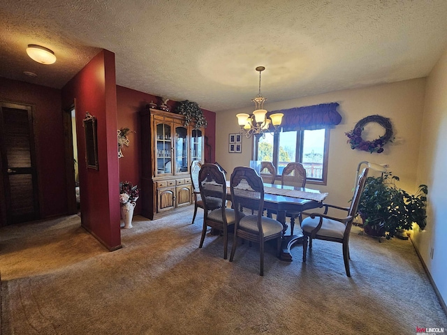 dining room with dark carpet, a textured ceiling, and a notable chandelier