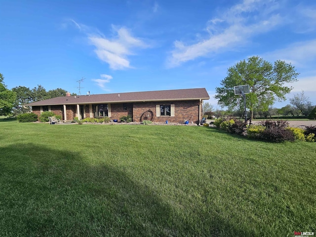 back of property featuring a yard