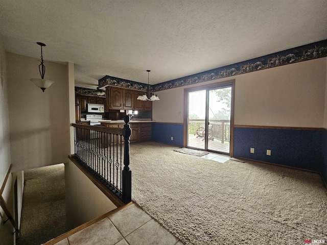 interior space with light carpet and a textured ceiling