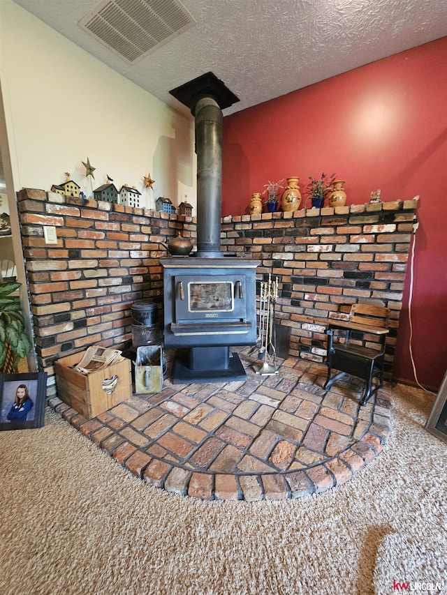 room details with carpet floors, a textured ceiling, and a wood stove