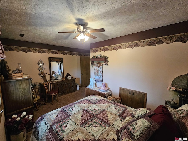 carpeted bedroom with ceiling fan and a textured ceiling