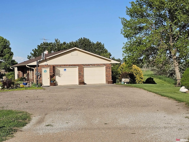 ranch-style home featuring a garage and a front yard