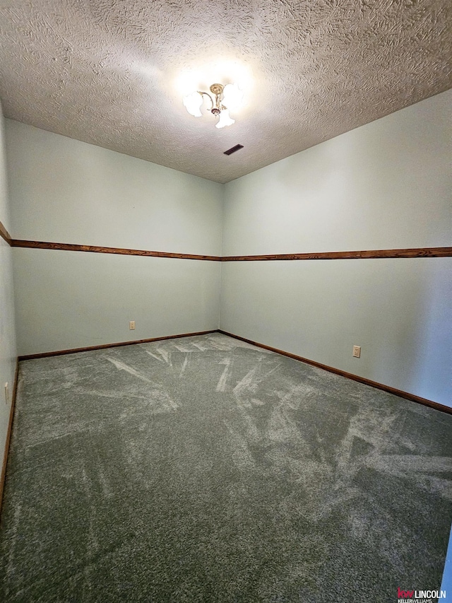 spare room with carpet flooring and a textured ceiling