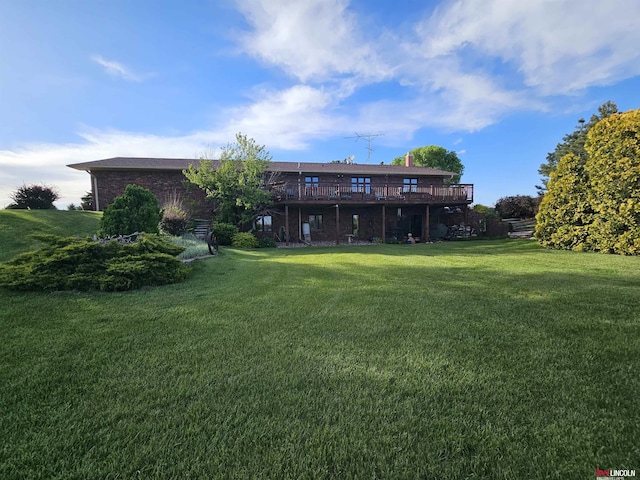 back of house with a deck and a lawn