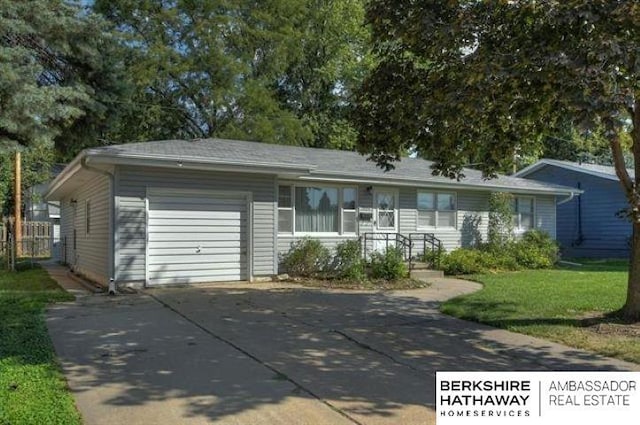 ranch-style home with a garage and a front yard