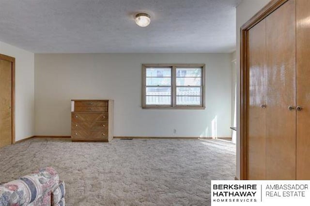 unfurnished bedroom with a closet, a textured ceiling, and carpet flooring