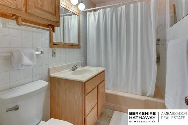 full bathroom featuring toilet, shower / tub combo, tile walls, vanity, and decorative backsplash