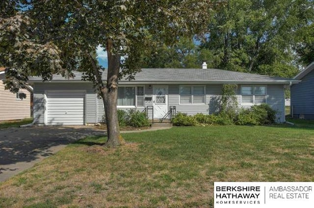 single story home featuring a garage and a front yard