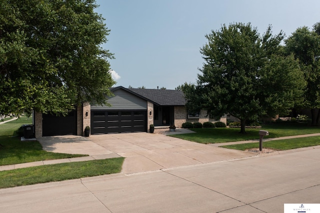 view of front of house with a garage and a front lawn