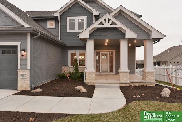 entrance to property with a garage and covered porch