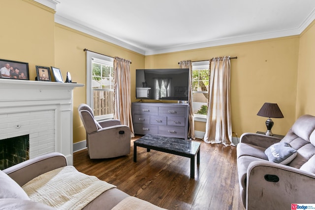 living room featuring plenty of natural light, crown molding, dark hardwood / wood-style flooring, and a brick fireplace