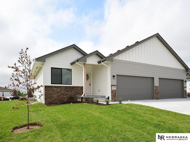 14801 Willow St, Bennington, NE 68007 - view of front facade featuring a garage and a front lawn
