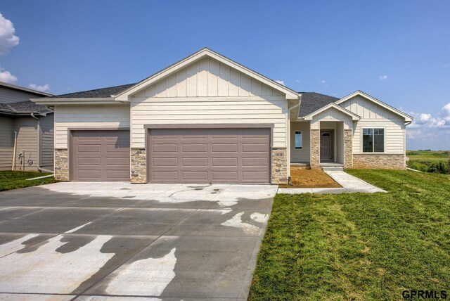 view of front of home featuring a garage and a front lawn