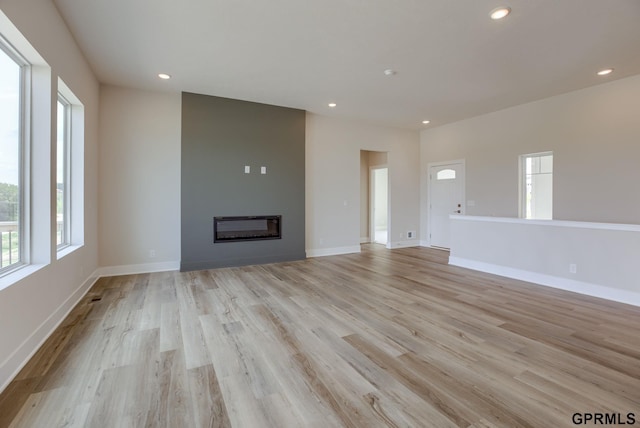 unfurnished living room with light hardwood / wood-style floors