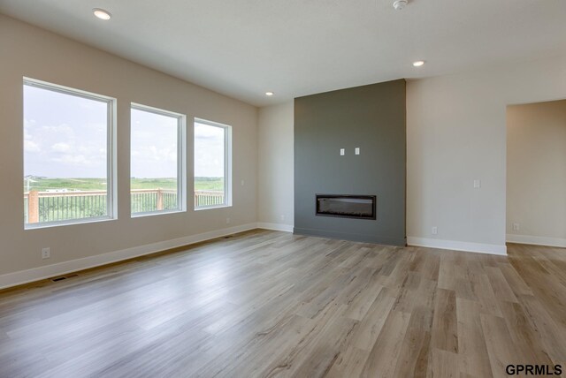 unfurnished living room featuring light hardwood / wood-style floors