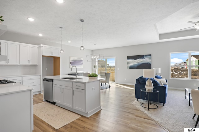 kitchen with sink, white cabinetry, ceiling fan with notable chandelier, and plenty of natural light