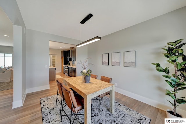 dining space with light wood-type flooring