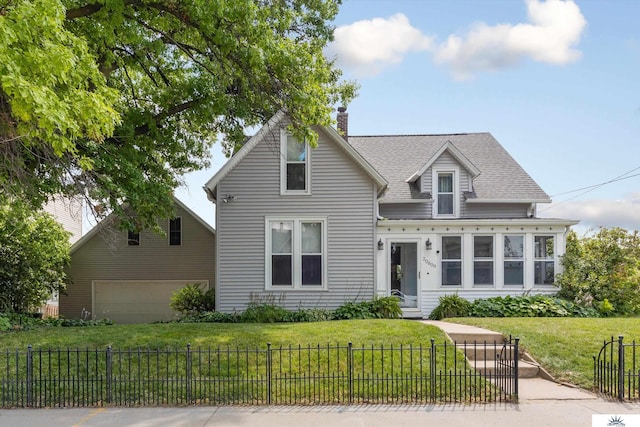 view of front of property with a garage and a front lawn