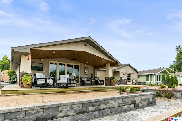 rear view of house featuring ceiling fan and a patio