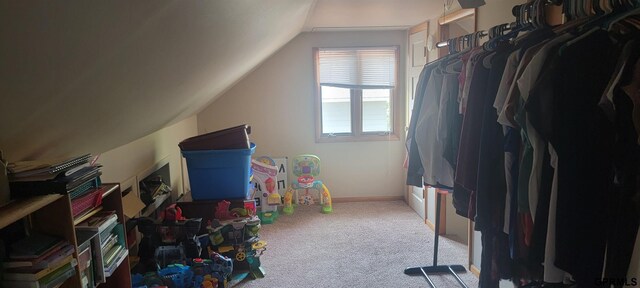 interior space with vaulted ceiling and carpet floors