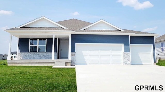 view of front facade featuring a garage, covered porch, and a front lawn