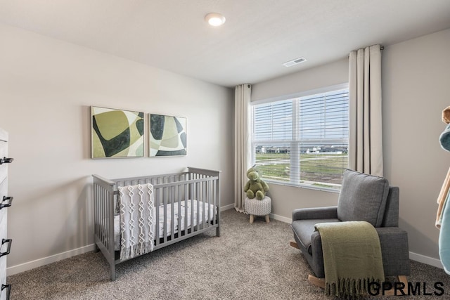 bedroom featuring carpet and a crib