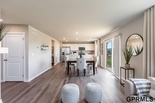 dining area with wood-type flooring