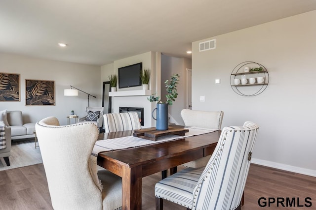 dining space with dark wood-type flooring