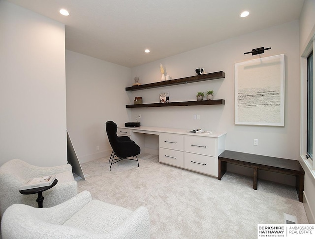 sitting room featuring light carpet