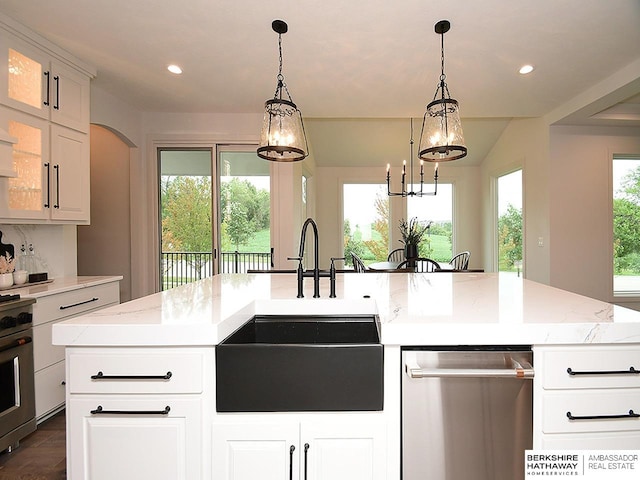 kitchen featuring appliances with stainless steel finishes, plenty of natural light, and a center island