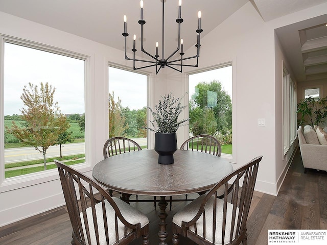 dining area with a notable chandelier, lofted ceiling, dark hardwood / wood-style floors, and a healthy amount of sunlight