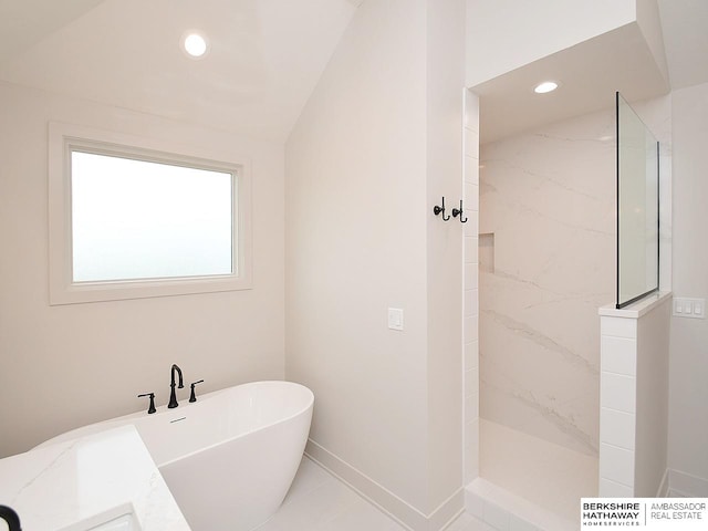 bathroom with lofted ceiling, tile patterned flooring, and separate shower and tub