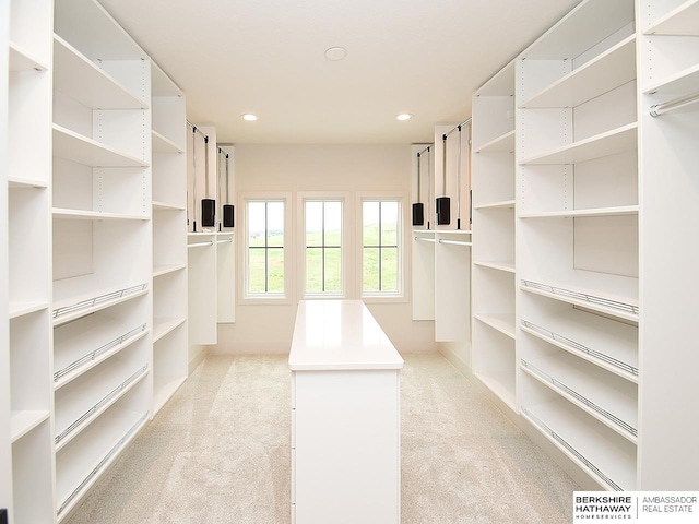 walk in closet featuring light colored carpet