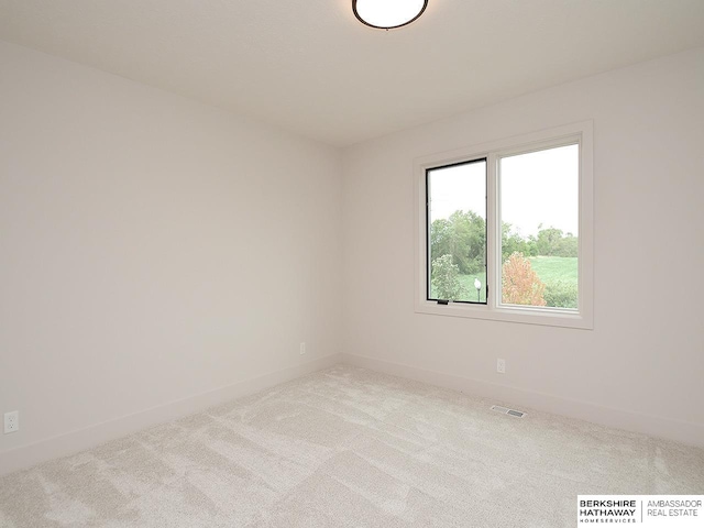 unfurnished room with light carpet