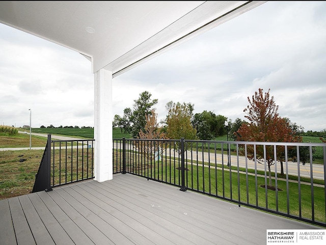 wooden terrace featuring a yard