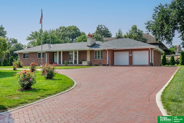 single story home with a garage and a front yard