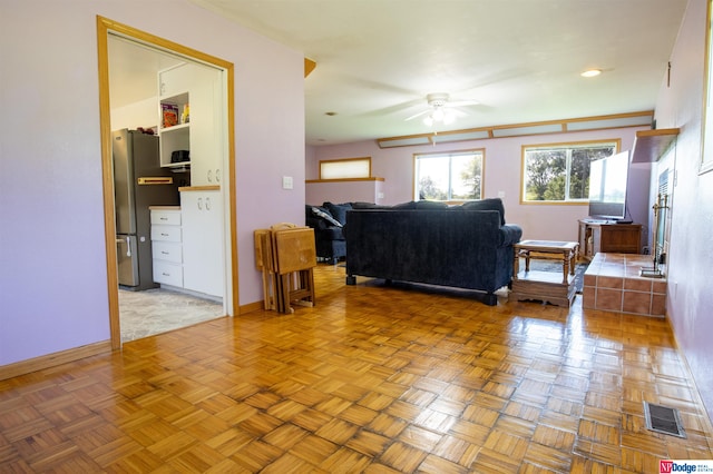 living room with light parquet floors and ceiling fan