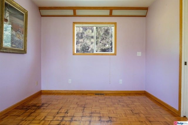 unfurnished room featuring parquet flooring